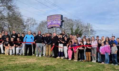 Hope Christian Academy head of school Nic Burns cuts the ribbon at Monday’s ceremonial opening of the school’s new sports home, at Oxford’s Big Jack Stovall Sports Complex.